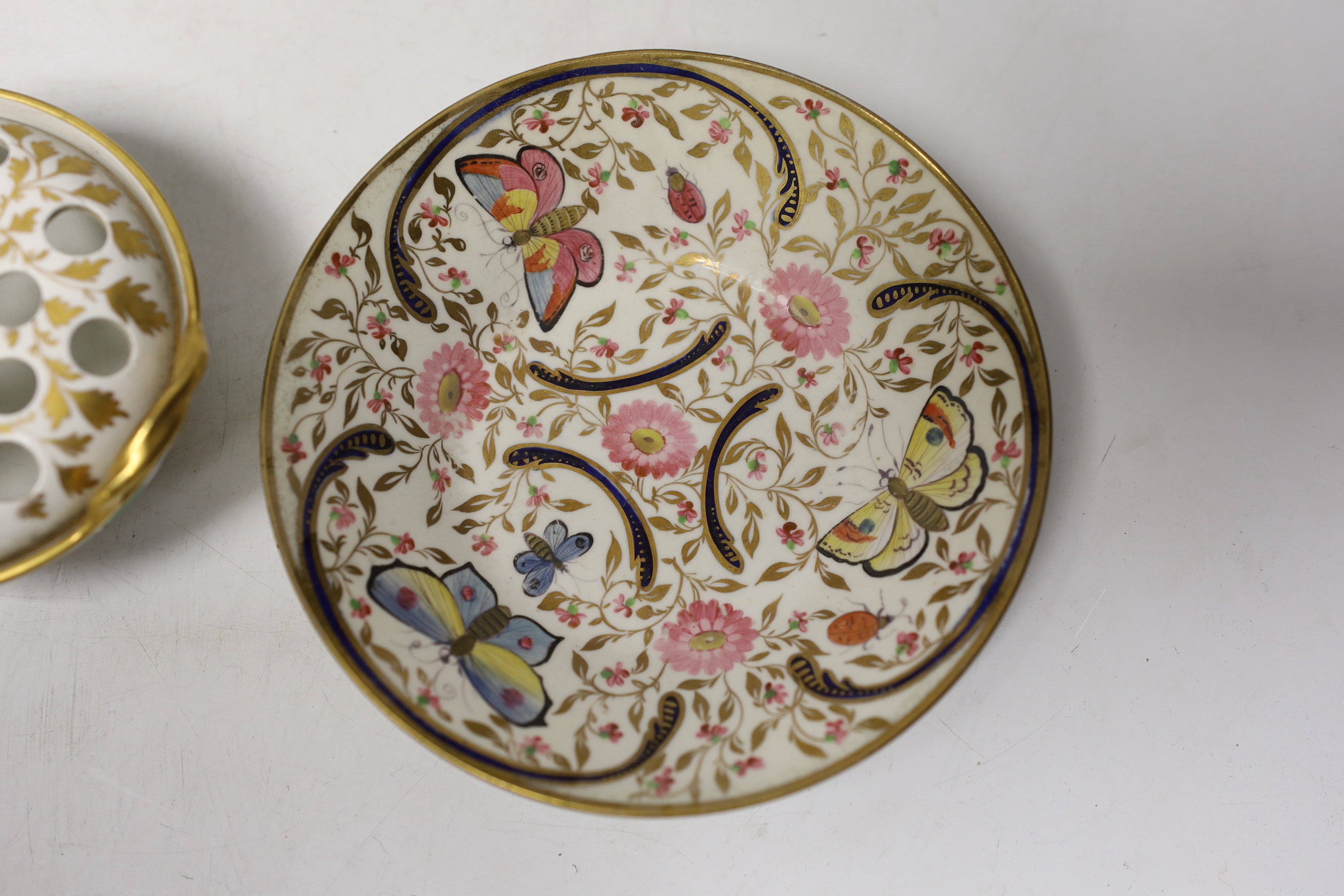 Early 19th century English porcelain including a Wedgwood pot pourri bowl and cover, two sauce tureens covers with integral stands, a butterfly painted trio and a bird painted spill vase